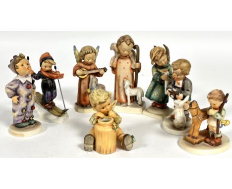 A collection of eight Hummel German pottery figures including, Carnival, Skier, Angel Serenade, Heavenly Angel, Prayer Before