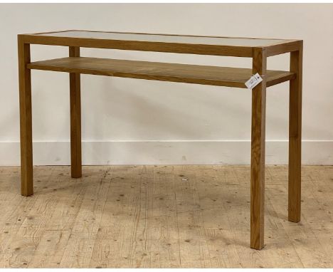 A contemporary oak console table, the top with inset glass panel raised on square section supports united by an under tier H8