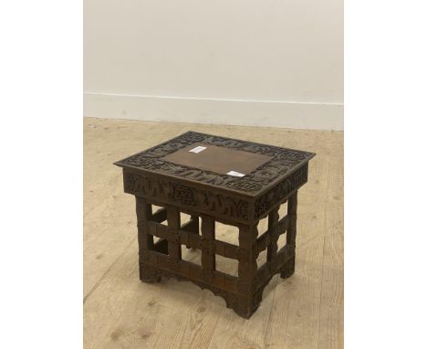 A Small chinese folding stool, late 19th / early 20th century, the top with incise carved border depicting dragons and shou s