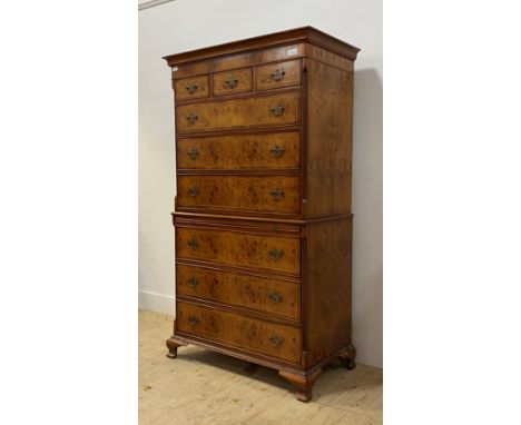 A Georgian style bur elm chest on chest, with projecting cornice over three short  and three long drawers, flanked by fluted 