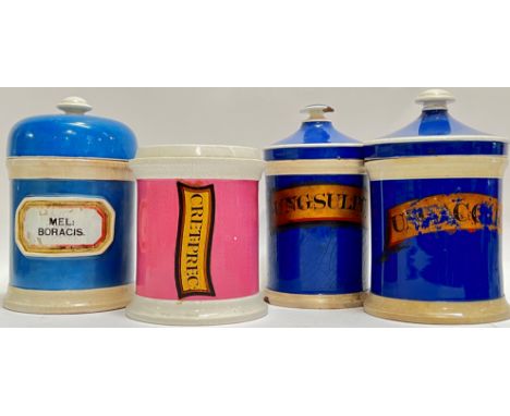 A group of four nineteenth century ceramic apothecary jars in blue and pink, variously labelled (Mel Boracis, Cret:Prec etc..