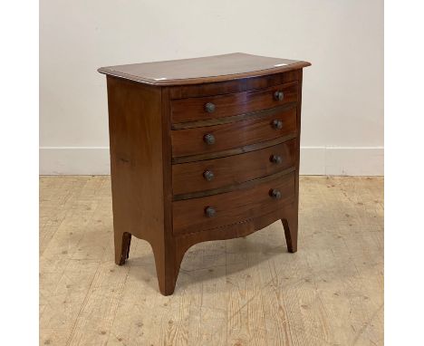 A 19th century mahogany bow front chest of small proportions, fitted with four graduated drawers, raised on long bracket supp