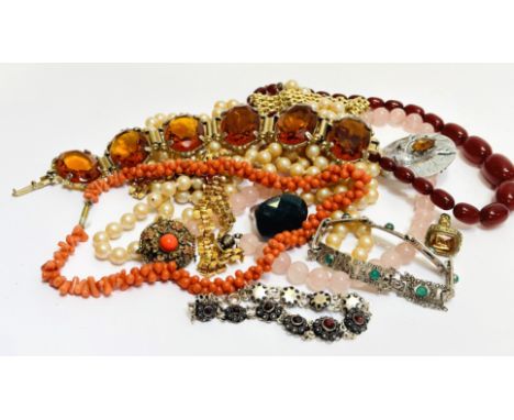 A collection of costume jewellery including a rose quartz beed necklace, coral bead and thong necklace, oval citrine glass pa