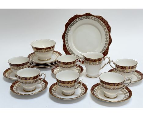 A Royal Staffordshire, Morning Glory red and gilt pattern tea service comprising a serving dish (w-24cm), six tea cups, a mil