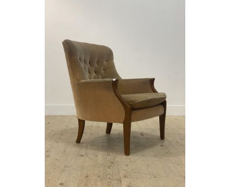 A Victorian style button back armchair, with yellow velvet upholstery, raised on tapered supports H87cm