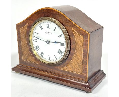 A Edwardian mahogany inlaid and boxwood strung arched mantle clock retailed by Rattray &amp; Co Dundee with white enamel dial