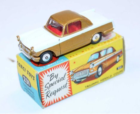 A Corgi Toys No. 231 Triumph Herald Coupe comprising of gold and white body with red interior and flat spun hubs, housed in t