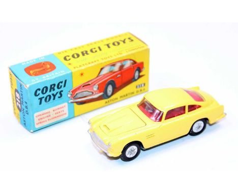 A Corgi Toys No. 218 Aston Martin DB4, finished in yellow with red interior and silver hubs, housed in the original blue &amp