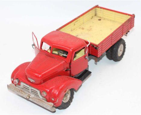 Gama No.501 battery operated and tinplate tipping truck, comprising red cab and back, black chassis, with spare tyre, model h