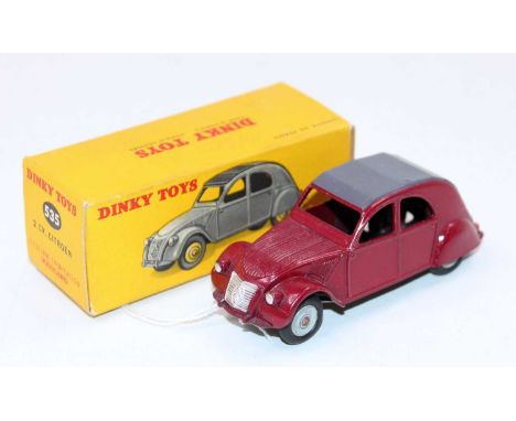 A French Dinky Toys No. 535 Citroen 2CV comprising of maroon body with grey roof complete with light grey hubs housed in the 