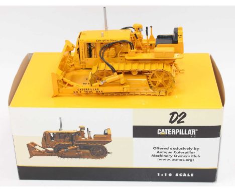 Speccast 1/16th scale diecast model of a CAT D2 Track Type Tractor with tool bar blade, housed in the original box (NMM-BNM)