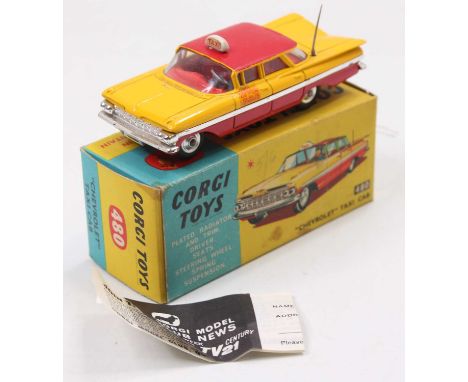 A Corgi Toys No. 480 Chevrolet Taxi Cab comprising of red and yellow body with white taxi roof sign, complete with driver and