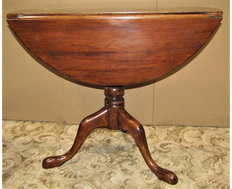 A Georgian style drop leaf occasional table, raised on a turned pillar and tripod, 86cm diameter together with a Edwardian dr