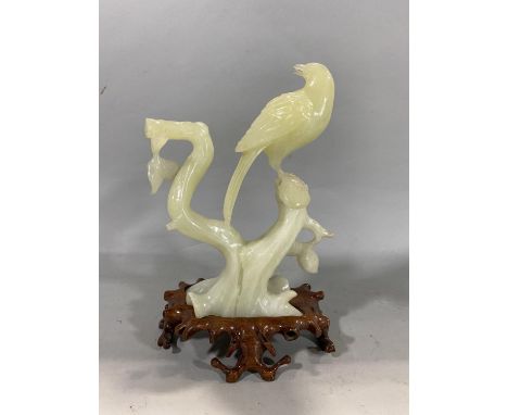 Chinese jade type carved study of a bird on a branch, 21cm high 