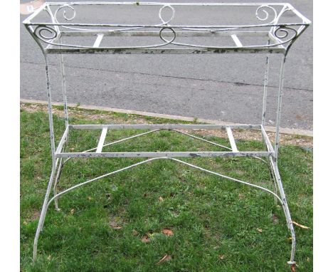 A decorative weathered cream painted ironwork two tier planter of rectangular form with simple decorative scrollwork detail, 