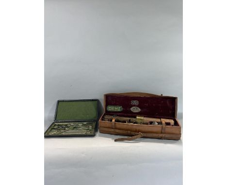 Cased 'The "Davon" Patent' leather clad sighting scope with leather case and pocket compass, the case inscribed 'Please retur