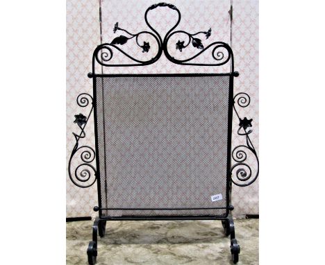A good quality Victorian wrought iron firescreen with floral and scrolled detail 