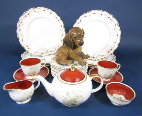 A German Rosenthal model of a seated dachshund puppy 15 cm tall approximately, together with a Suzy Cooper tea for two set co