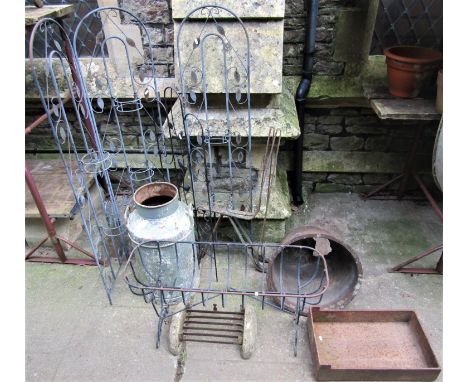 One lot of various vintage and later iron work to include a pair of simple strapwork bench ends, planter, old milk churn, cas