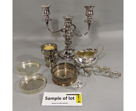 A mixed collection of silver plate comprising a twin branch candelabra, various wine coasters, tea wares, etc, to include a m