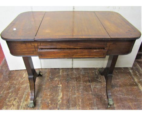 A Regency mahogany games table of rectangular form raised on a stretcher base with swept supports, enclosing a shallow frieze