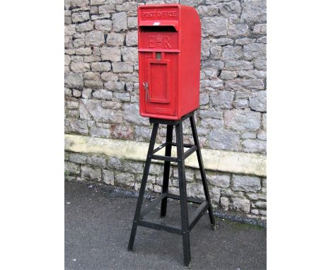 A reclaimed cast iron and alloy post box with traditional red livery raised lettering Post Office ER with central crown, Carr