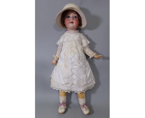 Large German bisque head doll circa 1920's with closing blue eyes, open mouth with teeth and jointed composition body, wearin