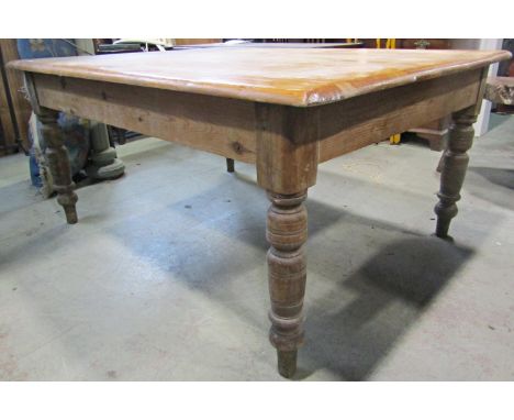 A pine farmhouse kitchen table, the rectangular top with moulded outline raised on four ring turned and tapered legs, 5ft lon