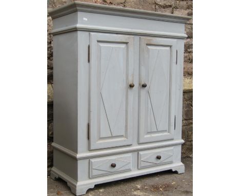 Painted and distressed cupboard enclosed by a pair of panelled doors over two frieze drawers on bracket supports, 110cm high 