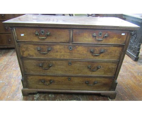A Georgian mahogany chest of three long and two short graduated drawers, set within reeded and canted column corners, set ben