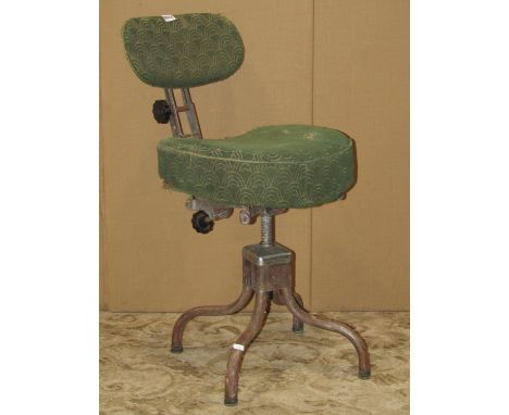 A vintage office chair on a swivel base with adjustable mechanism 