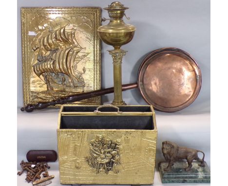 A collection of metal ware to include a brass Corinthian column oil lamp, a cast metal figure of a standing lion and a collec