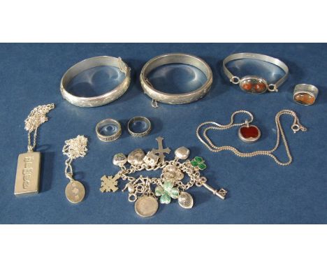 Collection of vintage silver jewellery to include a charm bracelet, two hinged bangles with engraved decoration, bracelet set