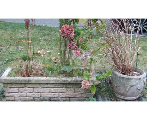 A reclaimed garden planter of rectangular form with simulated stone wall facade, 105 cm long x 36 cm wide (planted), together