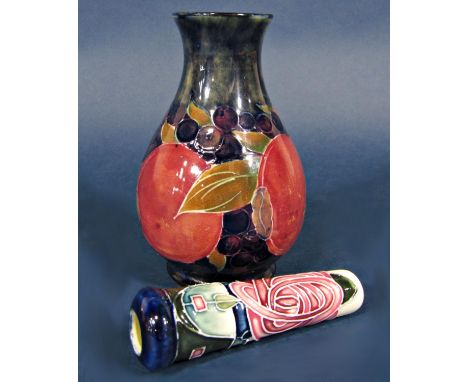 A Moorcroft vase with fruit decoration on a dark blue mottled ground with painted signature and impressed marks to base 12 cm