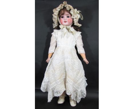 An early 20th century German bisque head doll by Schoenau &amp; Hoffmeister, marked '915 12½' with brown eyes, open mouth wit