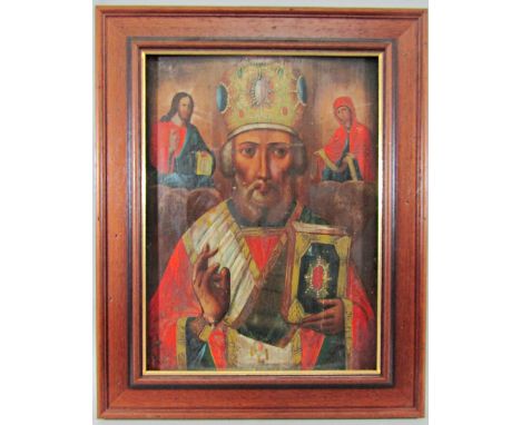 An eastern European icon (probably 19th century) with three quarter length portrait of a bearded male character flanked by Ch