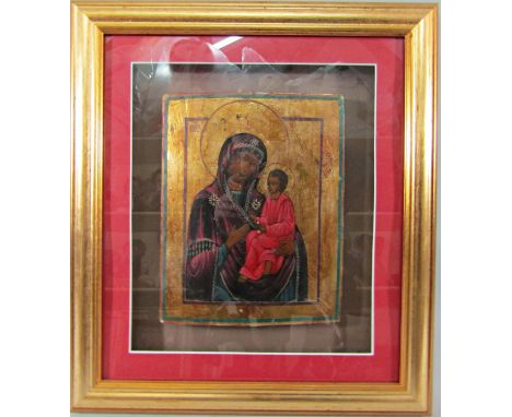 An eastern European icon (probably 19th century) three quarter length portrait of the Virgin and Child painted and gilded on 