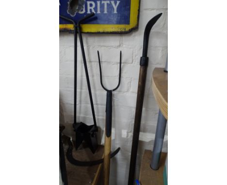 A pitch fork, a weeding tool, a potato planter etc