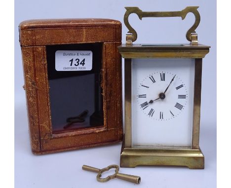 A brass carriage clock in leather case, with glass panel, height 5.5" overall