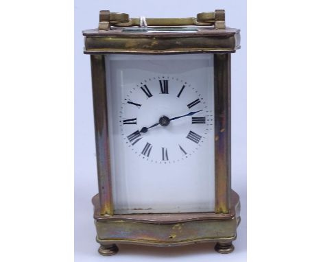 A brass carriage clock on feet, height 4.5"