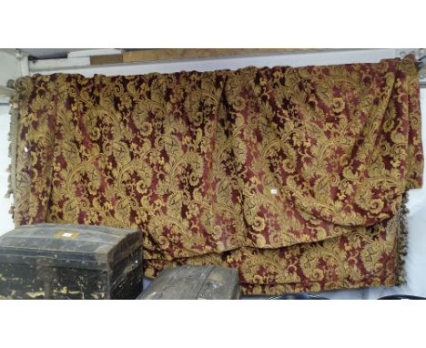 A pair of heavy gold and red velvet lined curtains