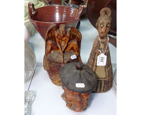 A Satan figure, a tobacco jar and another, and a stoneware decanter 
