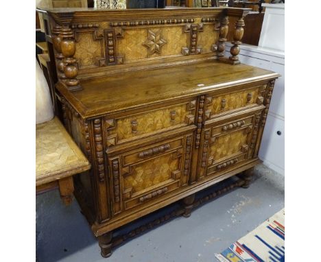 An ornate Continental oak and cube marquetry decorated sideboard, with raised panelled back, drawers and cupboards under, on 