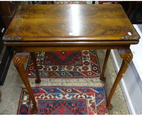 An Edwardian mahogany rectangular fold over card table, on shell carved cabriole legs, W67cm