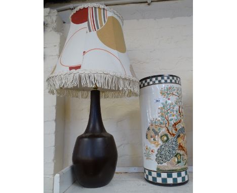 An Oriental stick stand, and a large table lamp and shade