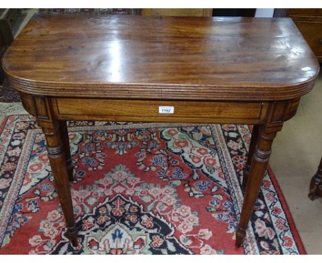 A Regency mahogany fold over card table, with ebony stringing raised on turned legs, W85cm