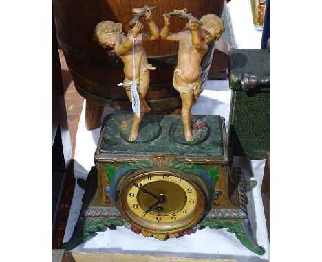 A Continental embossed and painted metal clock, surmounted by 2 cherubs, height 14.5"