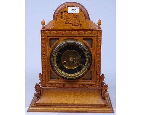 An 8-day mantel clock in carved and glazed oak case, 16"