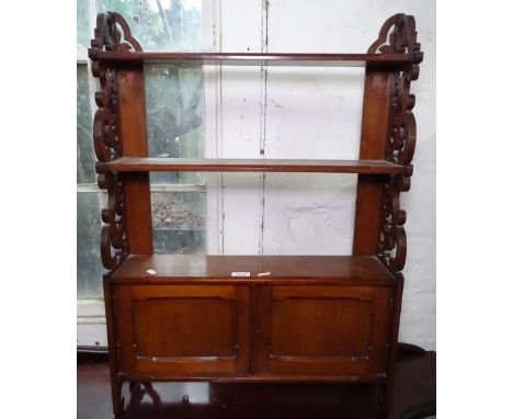 A Victorian mahogany hanging shelf with cupboard doors, and pierced scrolled sides, W61cm, H87cm